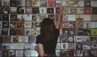 Girl looking at a wall of CDs