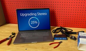 A computer with an upgrade loading on it, sitting on a workbench