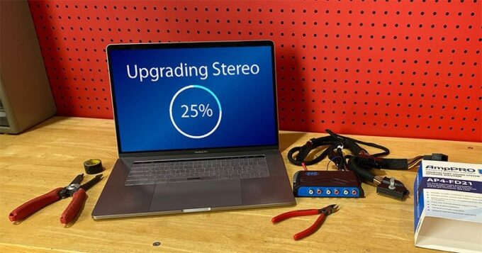 A computer with an upgrade loading on it, sitting on a workbench