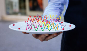 A man holding a plate with wavelengths on it