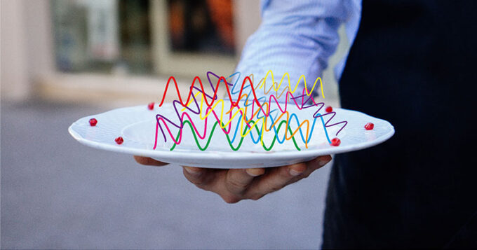 A man holding a plate with wavelengths on it