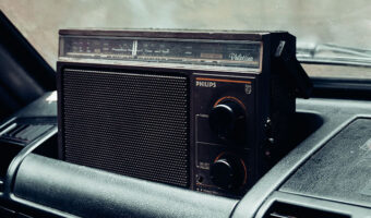 An old radio set in the dash of a vehicle