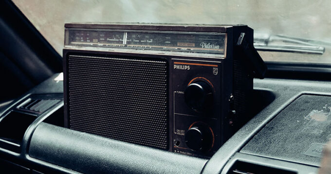 An old radio set in the dash of a vehicle
