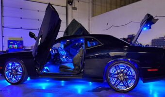 A car with a lighting upgrade shining out of all of the open doors